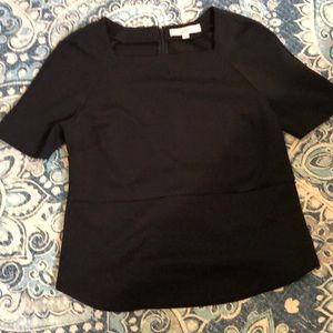 Black, poly top. Squared neckline, zipper back